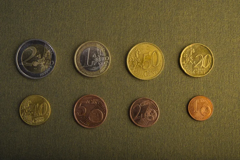 coins of euro and euro cents on a background of a dark golden background closeup currency of the euro union