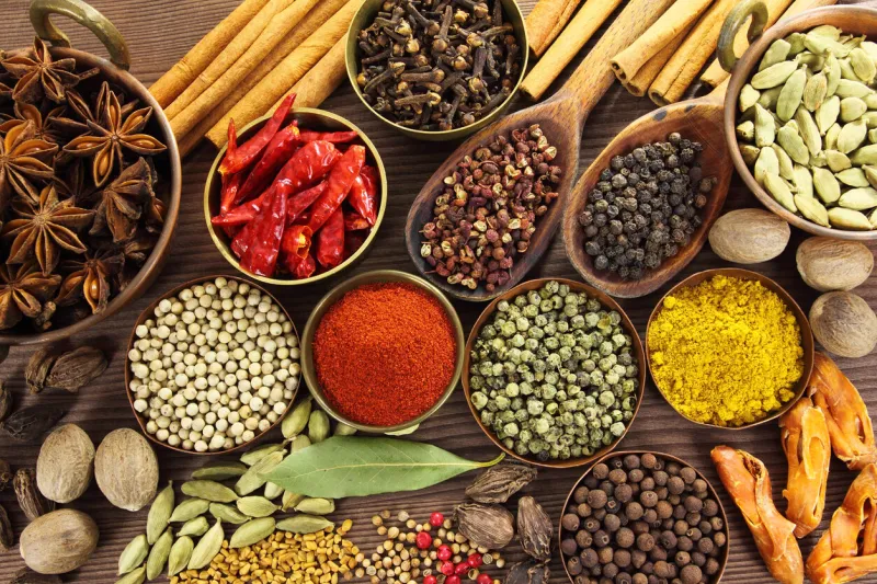 spices and herbs in metal bowls and wooden spoons food and cuisine ingredients