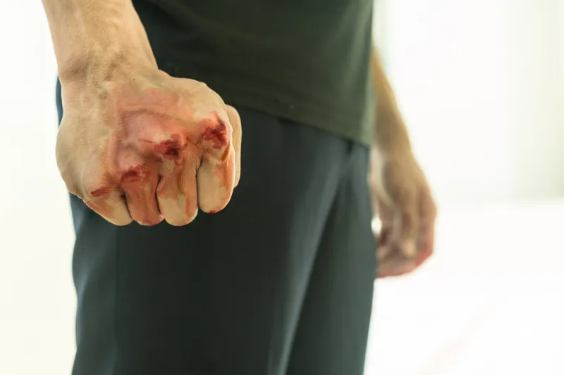 aggressive violent man in a fight, with a blood fist