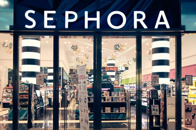 milan, italy - 17122020 sephora logo and showcase of the store at night with christmas decoration sephora is makeup, perfume, beauty cosmetics store
