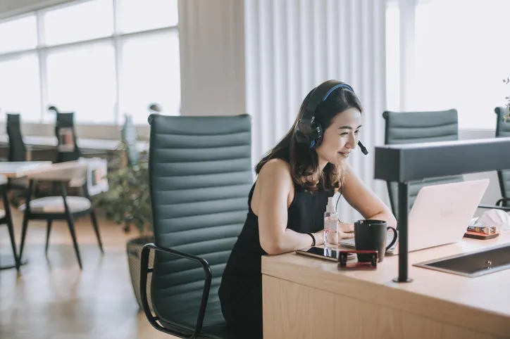 an asian chinese beautiful woman white collar worker talking to the camera video calling video conference with his business partners with face mask