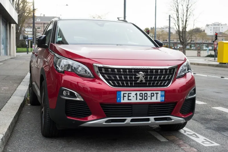mulhouse - france - 27 december 2020 - front view of red peugeot 3008 suv parked in the street