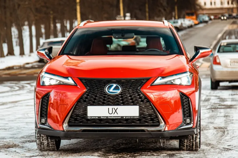 russia, moscow - february 05, 2020  red premium crossover hatchback lexus ux on the city streets hybrid car in winter