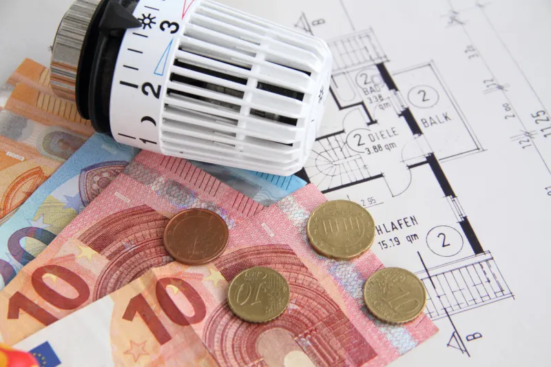 radiator thermostat, a socket and euro bills are on the table