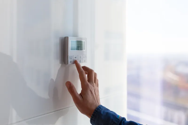the air conditioning and heating control panel for the apartment and office is located on a white wall