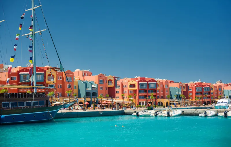 panoramic seascape on colorful marina promenade street from red sea with moored motor yachts marina, hurghada, egypt