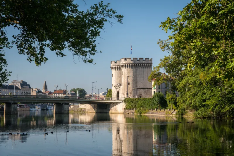 city gate and bridge over river meuse in verdun (france) on a sunny day in summer