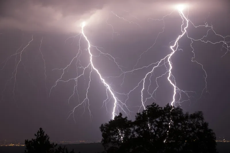 night shot of stunning lightning strikes over non-urban landscape