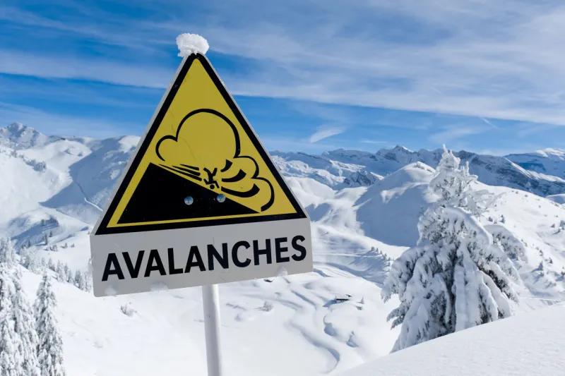 avalanche sign in winter alps with snow