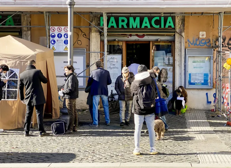 rome, italy, january 2022  people with protective masks waiting in line in front of a pharmacy to take a nasal swab to check for coronavirus infection