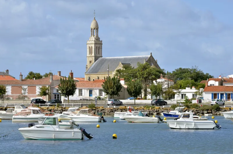 port of saint gilles croix de vie in with the church “sainte croix” in the background, commune in the vendée department in the pays de la loire region in western france