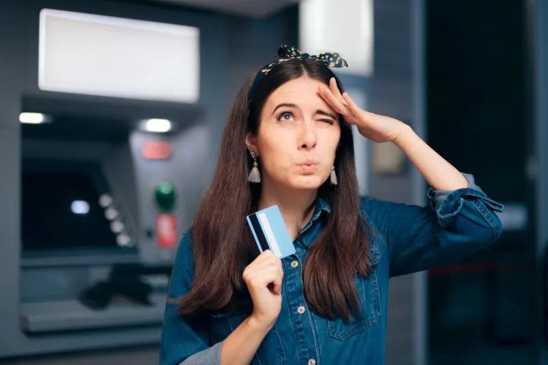woman in front of atm machine forgetting pin number