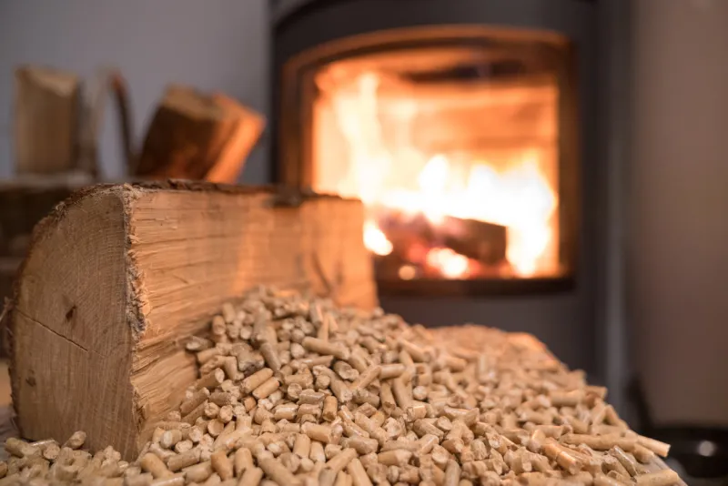 wood stove heating with in foreground wood pellets - economical heating system concept