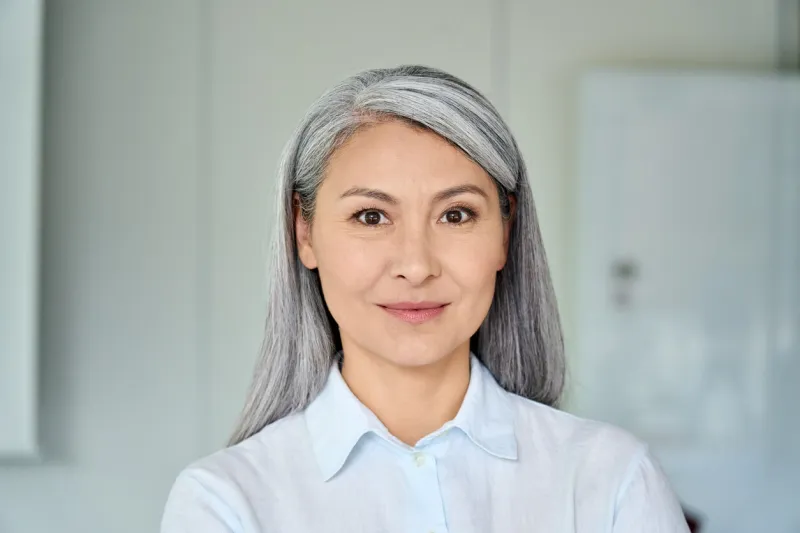 happy confident middle aged asian older senior female lawyer businesswoman corporation ceo in modern office looking at camera business woman executive concept closeup portrait headshot