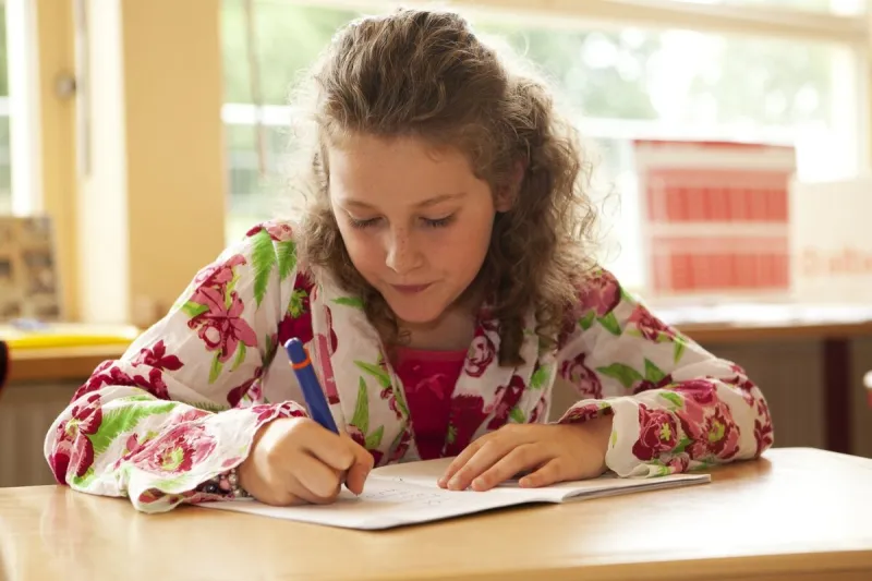 young female child writing