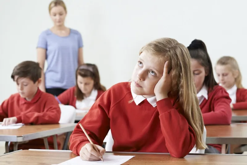 female pupil finding school exam difficult