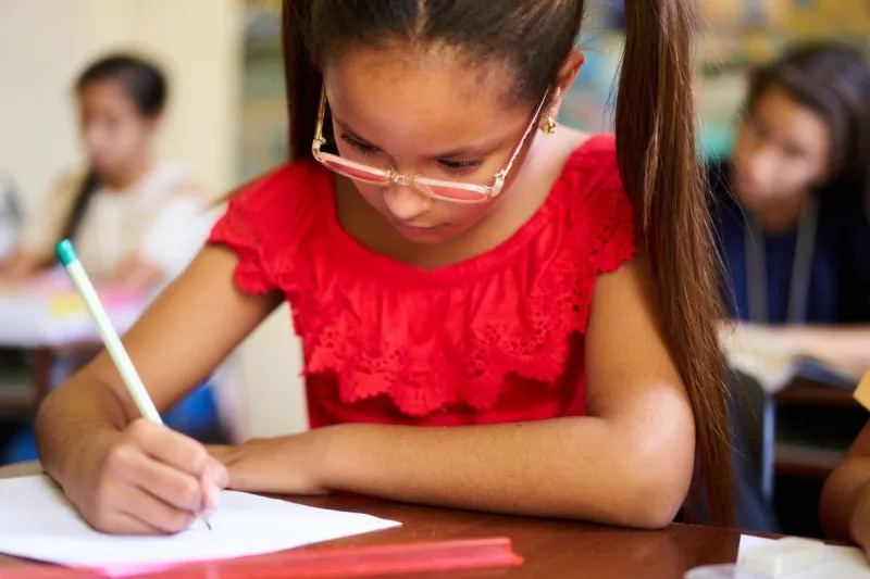 young people and education group of hispanic students in class at school during lesson girl with paper for admission test, examination