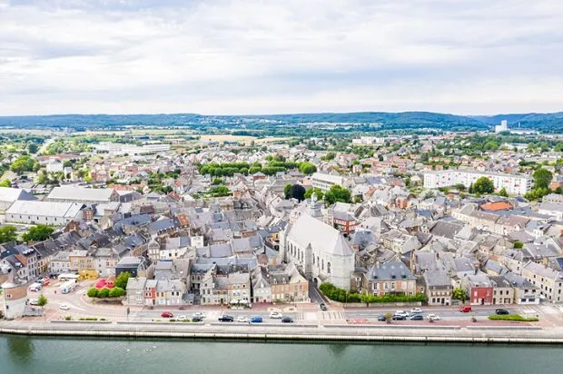 historical medieval givet town center with towers and churches near fortress of charlemont on the belgian border, meuse river ardennes department, grand est region of northeastern france
