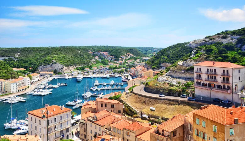 houses of bonifacio atop steep cliffs above the mediterranean sea, corsica, france