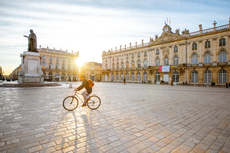 nancy, france - september 10, 2017  morning view on stanislas square with monument and man ride a bicycle at the old town of nancy city, france