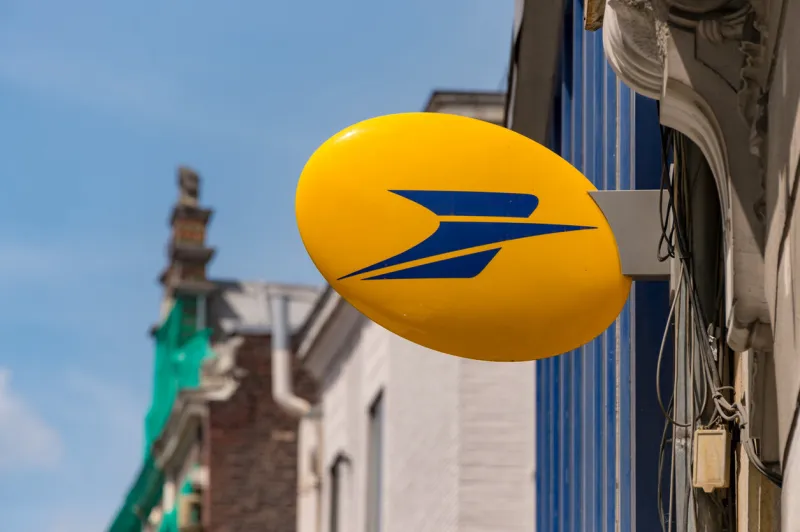 lille, france - 15 june 2018  logo of la poste, french national postal service on rue nationale