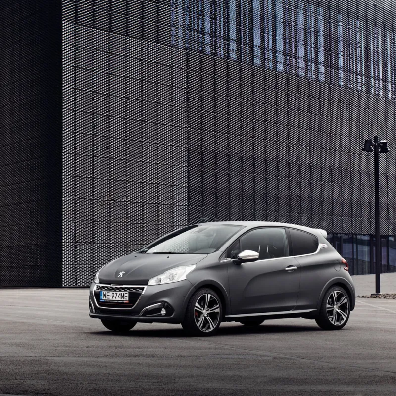peugeot 208 gti stands in front of a building convention center katowice, poland