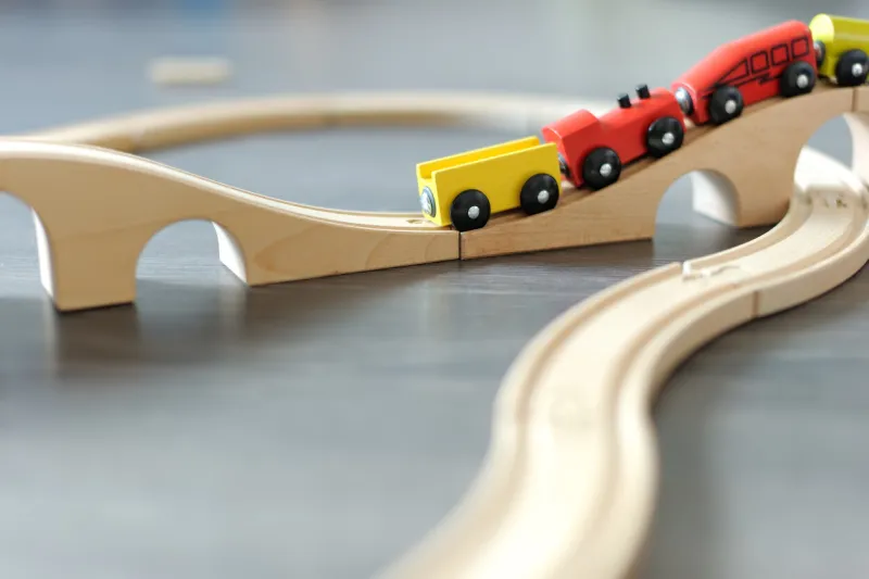 railway toy on floor in kid's room or playroom in entertainment centre cute trains and wooden rail road funny toy for boy education for young children on kindergarten development through the game