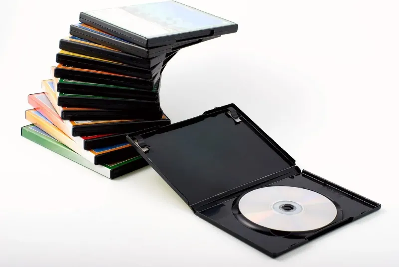 stack of packages and an open box dvd movies