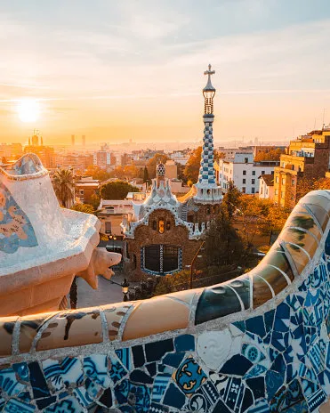 beautiful sunrise in barcelona seen from park guell park was built from 1900 to 1914 and was officially opened as a public park in 1926 in 1984, unesco declared the park a world heritage site