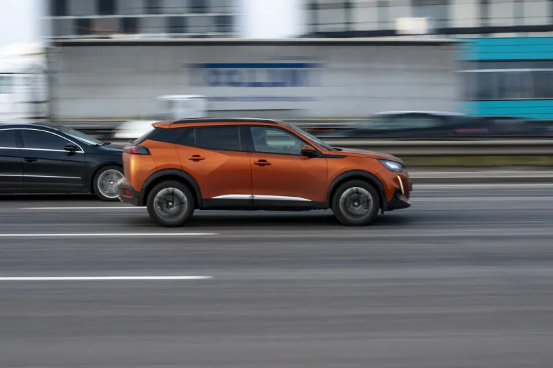 ukraine, kyiv - 11 march 2021  orange peugeot 2008 car moving on the street editorial