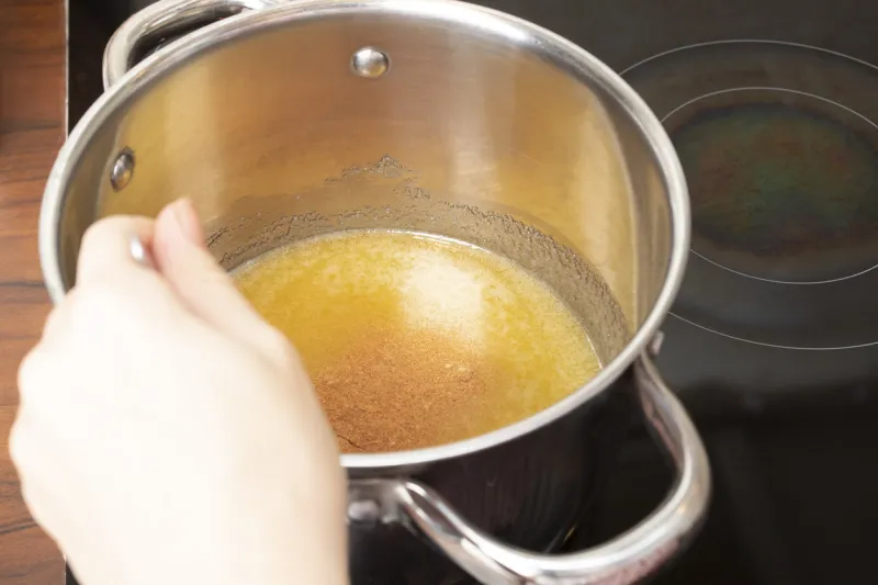 cooking dough for gingerbread, a pot of honey on the stove in the kitchen