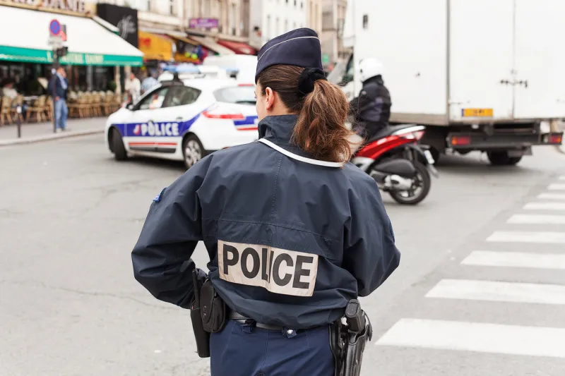 paris, france - may 15, 2013uniformed paris police officers patrolling traffic near the river seine in paris, france