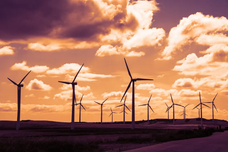 wind turbine field at sunset, dramatic sky