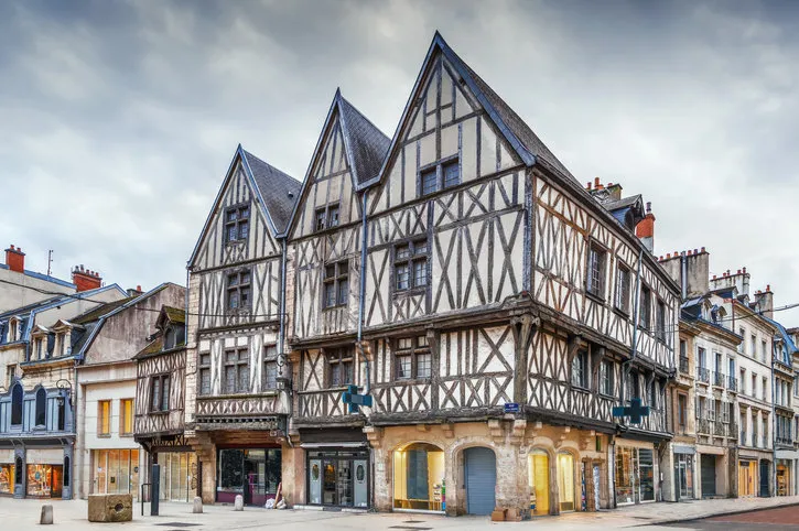 street with historical half-timbered houses in dijon, france