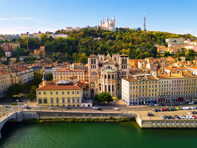 view from drone of cathedral of saint-jean and notre dame basilica on fourviere hill on bank of river saone in lyon, france