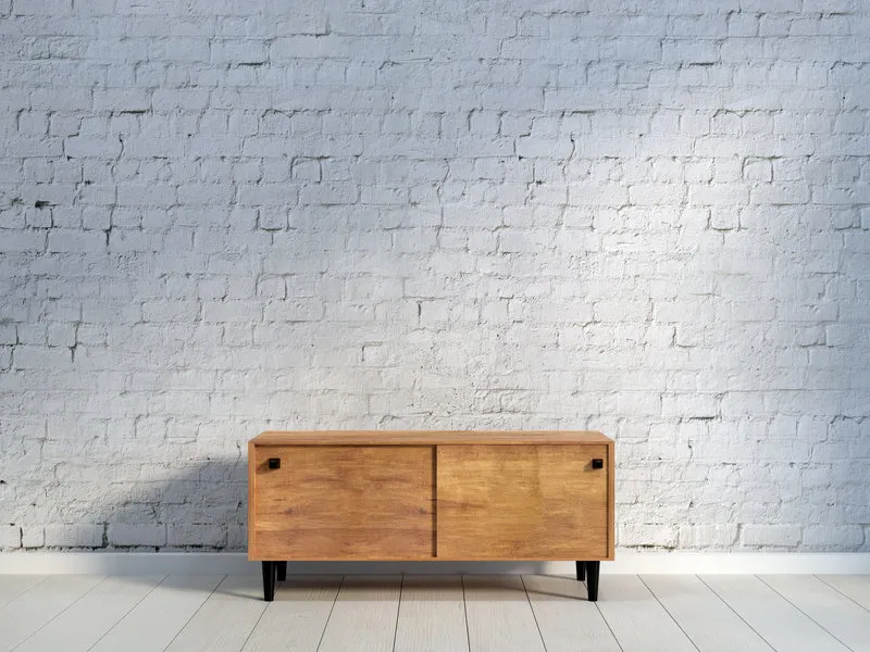 vintage wooden commode on light wooden floor at light brick wall background 3d rendering