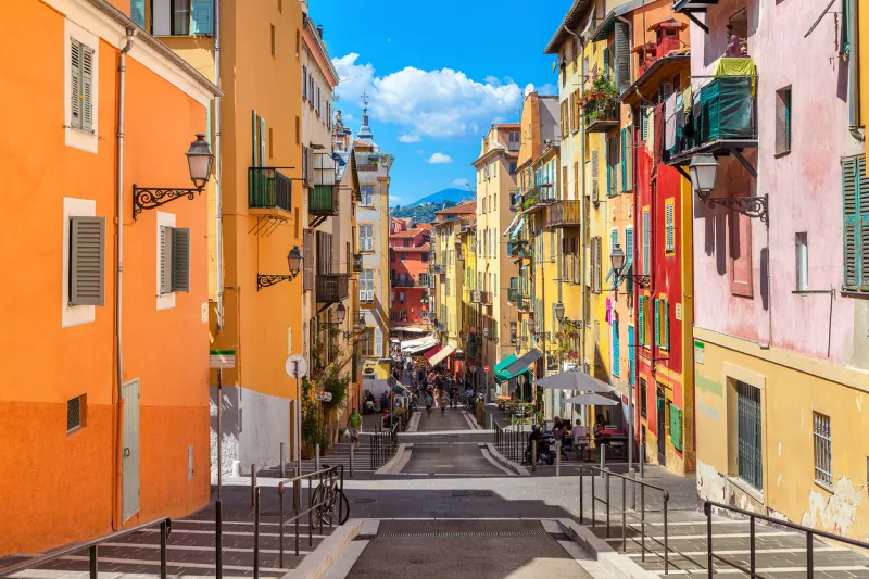 nice  narrow street in old tourist part of nice - fifth most populous city and one of the most visited cities in france, receiving 4 million tourists every year