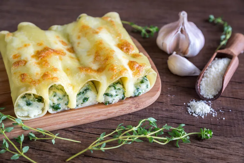 cannelloni with ricotta and spinach on the wooden board