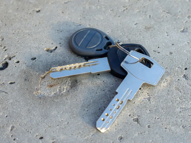 bunch of keys on a road concept image of lost or dropped keys close-up, selective focus