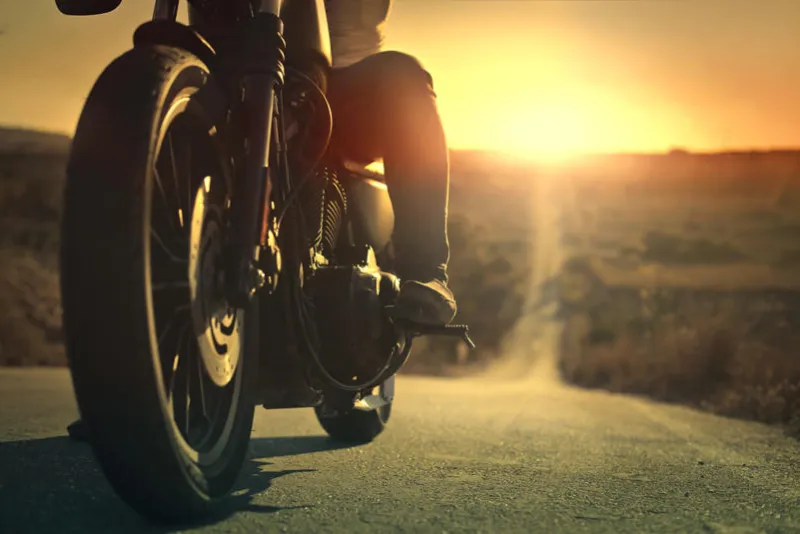 on a roaring motorcycle at sunset