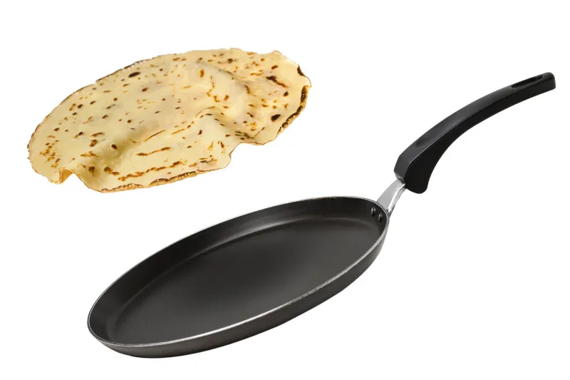 a nonstick pan flipping a crepe isolated on white