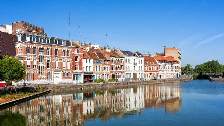 lille, france - may 2018 old houses located at the wault quay near the citadel of lille shot against a clear blue sky