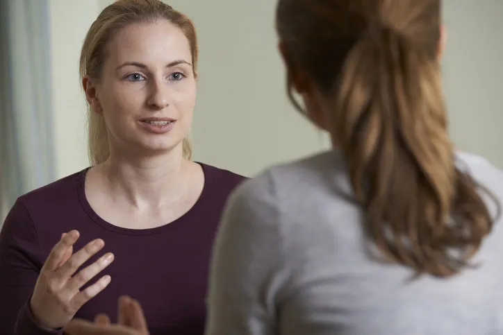 young woman discussing problems with counselor