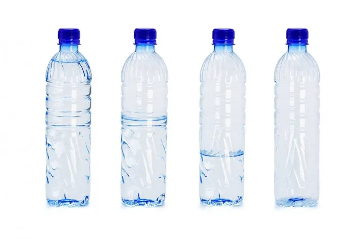 plastic bottles with different water levels inside