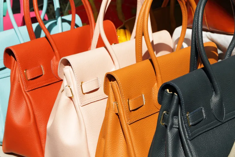 vivid fine leather handbags collection on san lorenzo market in florence, italy, europe
