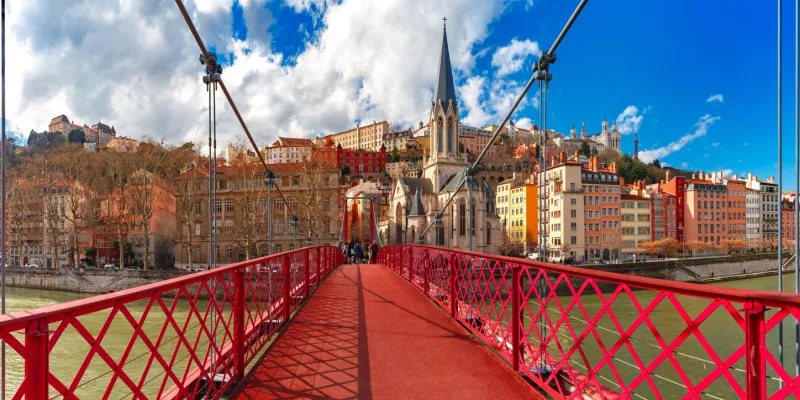 panoramic view of saint georges church and pedestrian footbridge across saone river, old town with fourviere cathedral in the sunny day in lyon, france