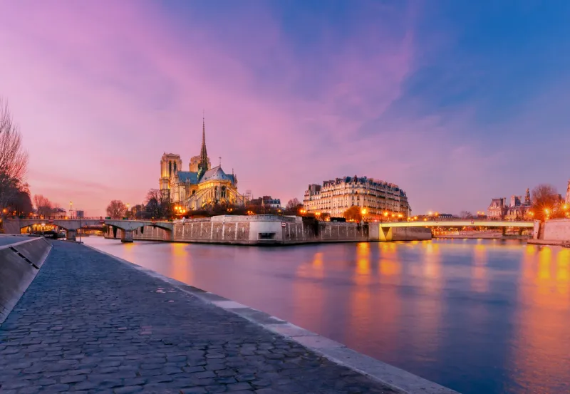 notre dame de paris and the river seine at sunset
