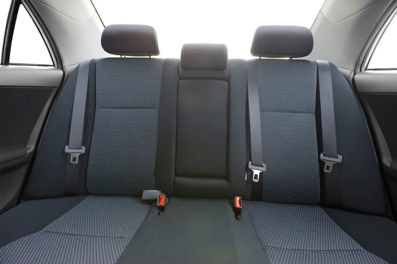 car interior with back seats, sunlight flaring through