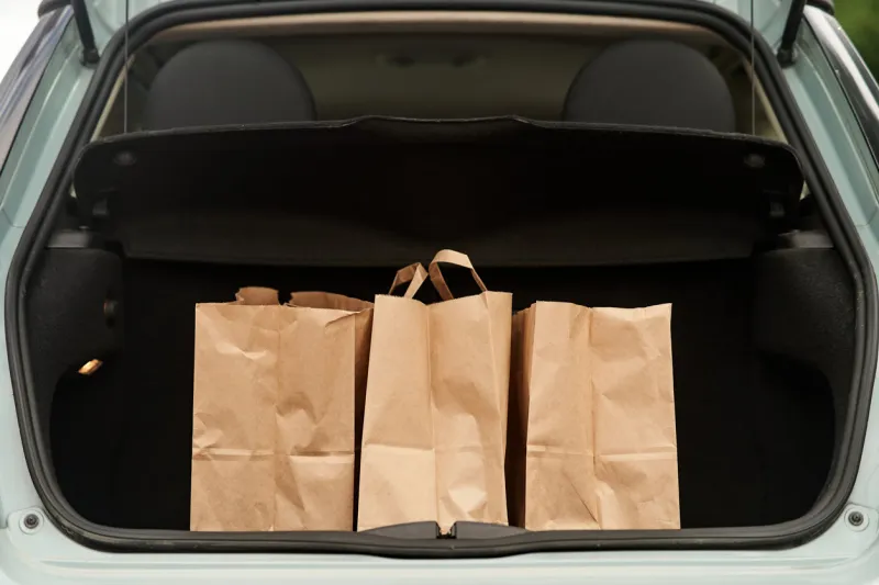 blank paper bags in a car trunk high-quality photo