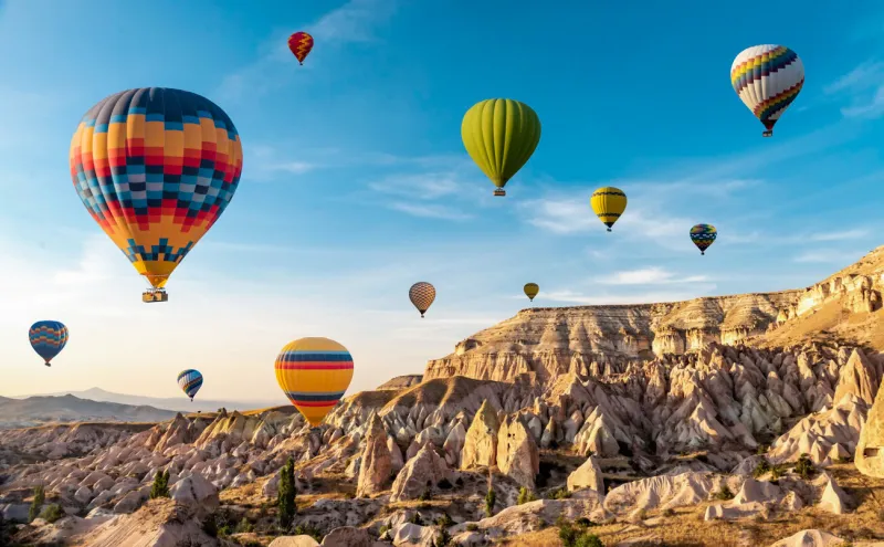 hot air balloon flying over spectacular cappadocia, uchisar - goreme, turkey
